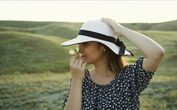 Free Stock Video Woman In The Countryside Smelling A White Flower