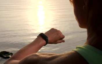 Free Stock Video Woman Checks Her Smart Watch While Watching Sunset