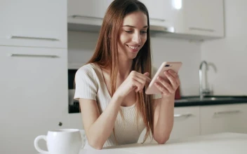 Stock Footage Woman Checking Facebook On Mobile Smiles