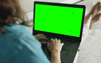 Stock Footage Woman Browsing Website On Laptop Greenscreen In Bed