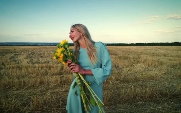 Stock Footage Woman And Sunflowers In The Countryside