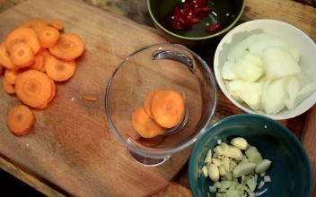 Stock Footage Woman Adding Chopped Carrots To A Bowl