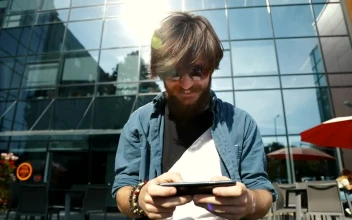 Stock Footage Winner Celebrates Victory In Mobile Game On City Street