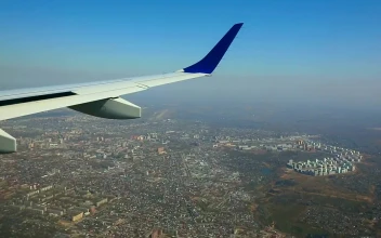 Stock Footage Wing View Of An Airplane Flying Above The City