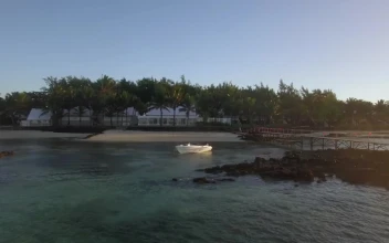 Stock Footage White Boat Anchored By A Small Beach