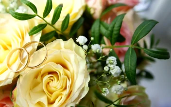 Stock Footage Wedding Rings Over Yellow Flowers