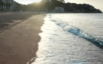 Stock Footage Waves Breaking By A Coastal Town