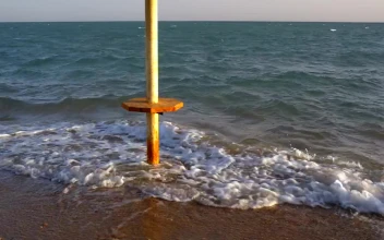 Stock Footage Waves Breaking Around An Umbrella
