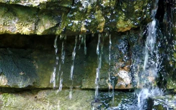 Stock Footage Water Running Off Rocks