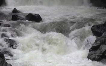 Stock Footage Water Flowing Down The River Between Black Rocks