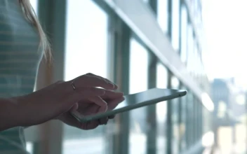 Stock Footage Walking Quickly With A Tablet