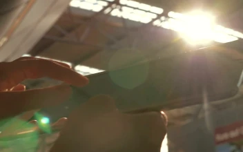 Stock Footage Using A Tablet Under Bright Sunshine