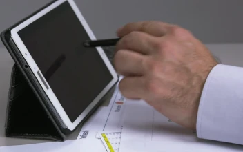 Stock Footage Using A Tablet Calculator