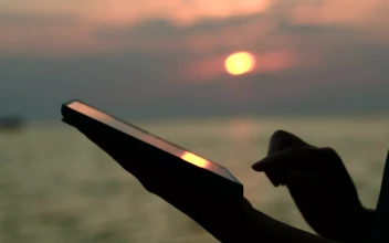 Stock Footage Using A Tablet At Sunset