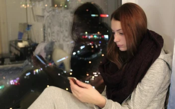 Stock Footage Using A Smartphone By The Window