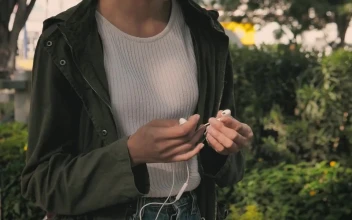 Stock Footage Urban Woman Putting On Her Headphones While Walking