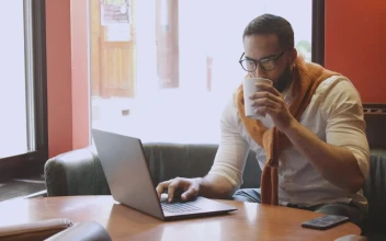 Stock Footage Urban Man Sips Coffee While Working In Cafe