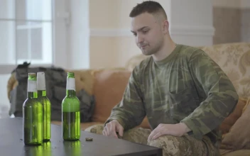 Stock Footage Upset Army Veteran Sits On Sofa Drinking Beer
