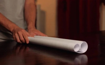 Stock Footage Unrolling A World Map On A Table