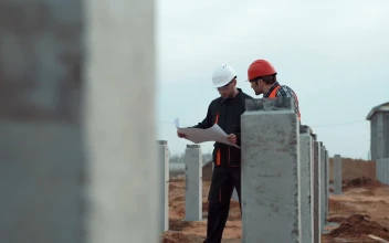Stock Footage Two Workers With Blueprint In Construction Site