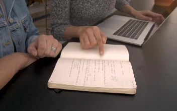 Stock Footage Two People Working On A Black Table