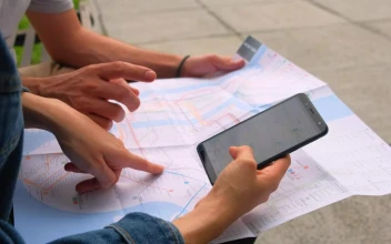 Stock Footage Two People Sitting On A Bench Looking At Maps Of