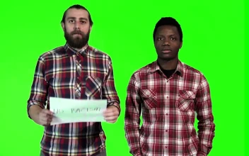 Stock Footage Two Men Holding Up A No Racism Sign