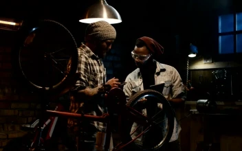 Stock Footage Two Mechanics Talking In A Bike Workshop