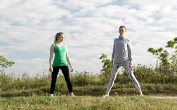 Stock Footage Two Girls Doing Yoga In A Field