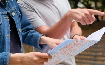 Stock Footage Two Friends Walking Through A Park While Looking At A
