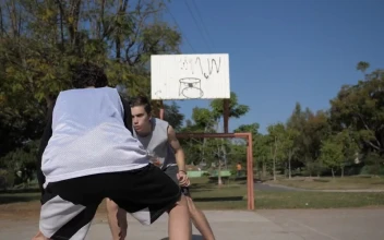 Stock Footage Two Boys Playing Basketball At An Outdoor Court