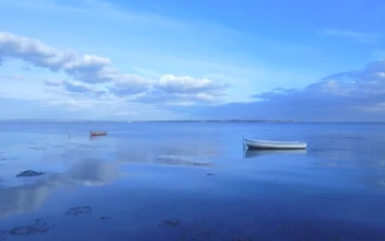 Stock Footage Two Boats Anchored Off The Shore
