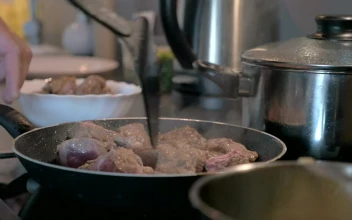 Stock Footage Turning Meat In A Frying Pan