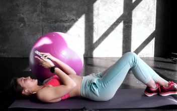 Stock Footage Woman Choosing Music During Her Workout