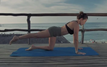 Stock Footage Woman Doing Yoga On A Deck At The Beach Free