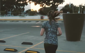 Stock Footage Woman Jogging Through Parking Lot Free