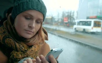 Stock Footage Woman Using Her Phone On A Rainy Day Free