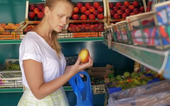 Stock Footage Woman Picking Fruit In A Small Shop Free