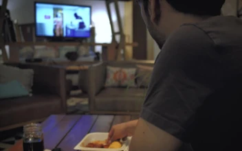 Stock Footage Young Man Eating While Watching Television Free