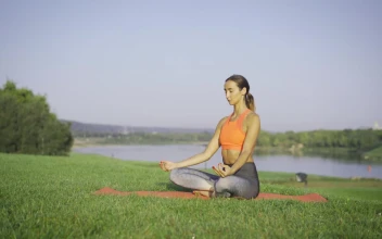 Stock Footage Woman Meditating On The Grass Near The River Free