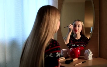 Stock Footage Woman Doing Her Makeup In The Mirror Free