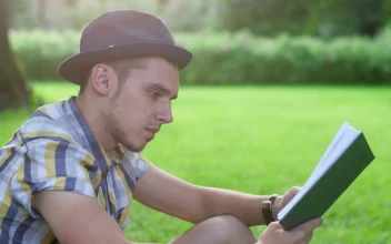 Stock Footage Young Man Reading A Book In The Park Free
