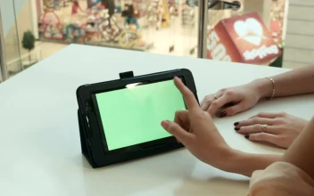 Stock Footage Woman Scrolling On A Tablet In A Shopping Mall Free