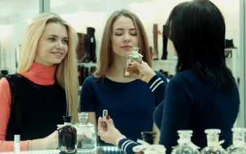 Stock Footage Woman Smelling Perfumes In The Shop Free