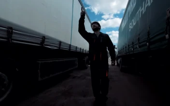 Stock Footage Worker Walking Between Two Freight Trucks Free