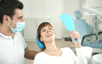 Stock Footage Woman Looks At Teeth In Dentist Office Mirror Free