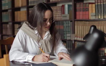 Stock Footage Woman Writing Her Homework In The Library Free