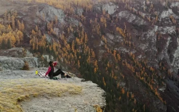 Stock Footage Woman On A Cliff With Mountains In The Background Free
