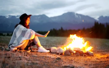 Stock Footage Woman Warming Her Hands Over A Hot Campfire Free