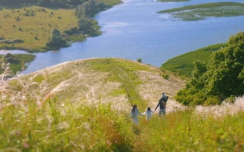 Stock Footage Young Family Walking Down The Hill With A Lake In Free